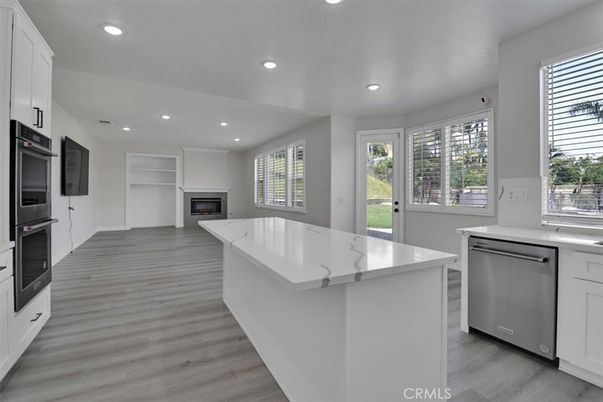 Fireplace, Interior, Kitchen, Recessed Lighting, Stainless Steel Appliances, Wood Texture Flooring