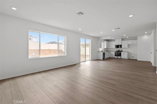 Empty room, Interior, Kitchen, Recessed Lighting, Stainless Steel Appliances, Wood Texture Flooring