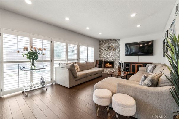 Fireplace, Interior, Living room, Recessed Lighting, Stone Walls, Wood Texture Flooring