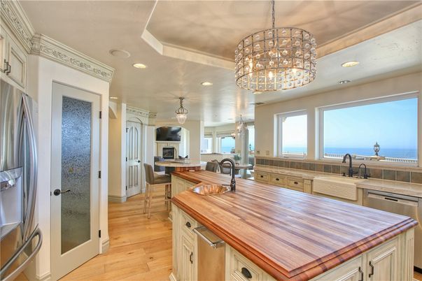 Chandelier, Dining room, Fireplace, Interior, Kitchen, Pendant Lights, Recessed Lighting, Stainless Steel Appliances, Water, Wood Texture Flooring