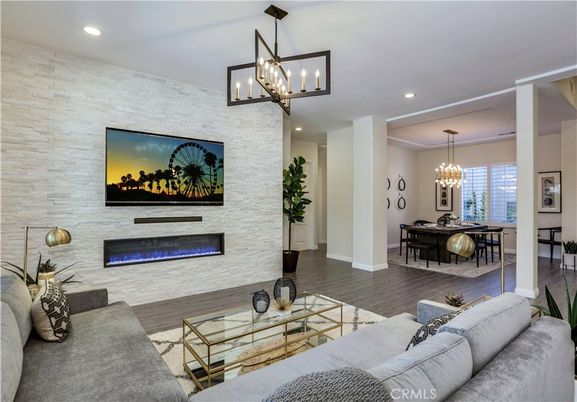 Chandelier, Dining room, Fireplace, Interior, Living room, Pendant Lights, Recessed Lighting, Stone Walls, Wood Texture Flooring
