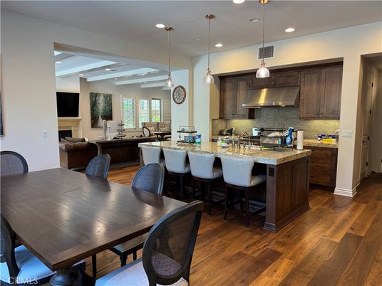 Dining room, Fireplace, Interior, Kitchen, Pendant Lights, Recessed Lighting, Stainless Steel Appliances, Wood Texture Flooring