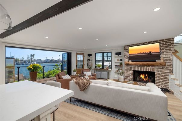 Fireplace, Interior, Living room, Recessed Lighting, Stone Walls, Water, Wood Texture Flooring