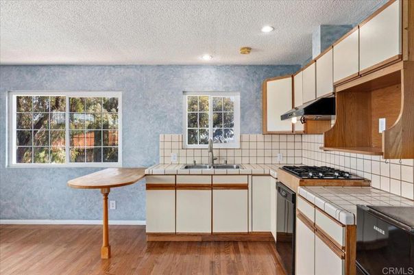 Interior, Kitchen, Recessed Lighting, Tile Countertops, Wood Texture Flooring