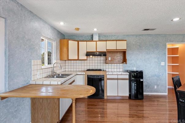 Interior, Kitchen, Recessed Lighting, Tile Countertops, Wood Texture Flooring