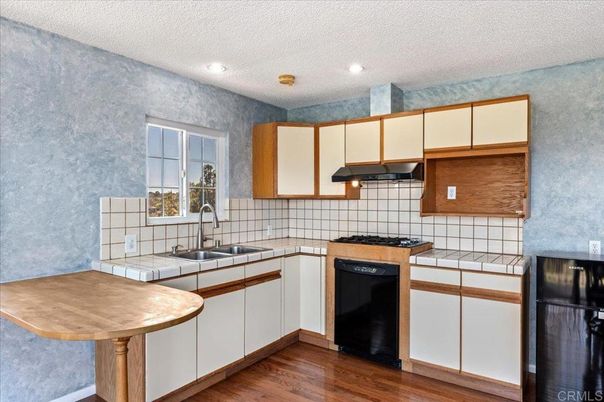 Interior, Kitchen, Recessed Lighting, Tile Countertops, Wood Texture Flooring