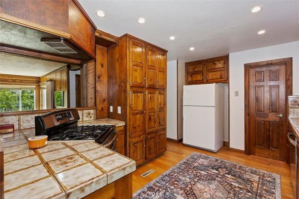 Interior, Kitchen, Recessed Lighting, Tile Countertops, Wood Texture Flooring