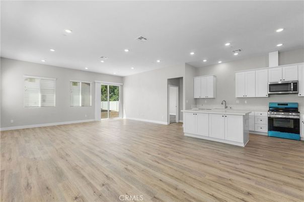 Empty room, Interior, Kitchen, Recessed Lighting, Stainless Steel Appliances, Wood Texture Flooring