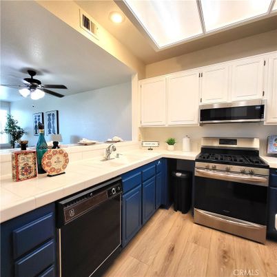 Interior, Kitchen, Recessed Lighting, Stainless Steel Appliances, Tile Countertops, Wood Texture Flooring