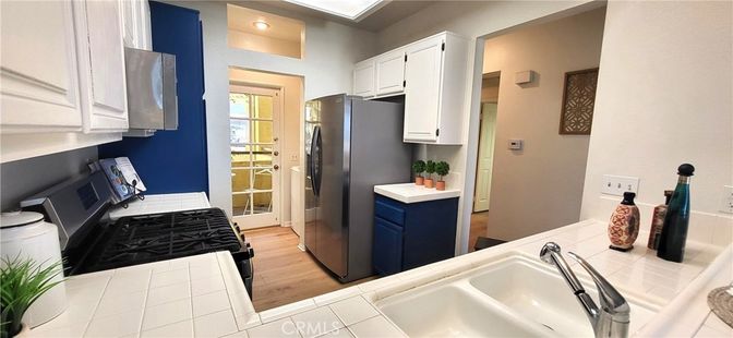 Interior, Kitchen, Recessed Lighting, Tile Countertops, Wood Texture Flooring