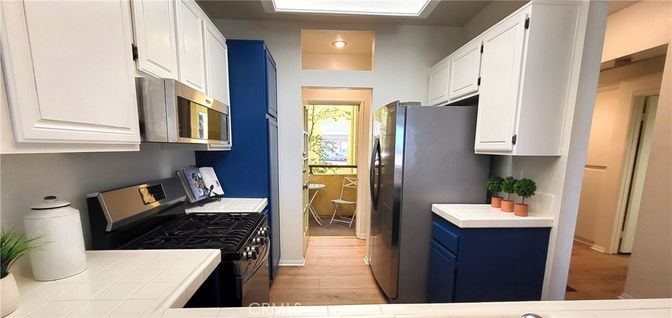 Interior, Kitchen, Recessed Lighting, Tile Countertops, Wood Texture Flooring