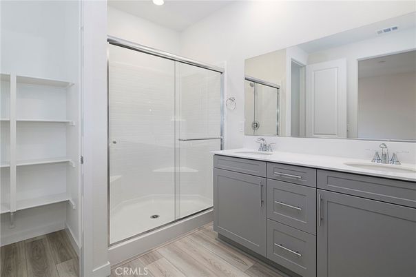Bathroom, Dual Sink Vanities, Glass Shower, Interior, Recessed Lighting, Wood Texture Flooring