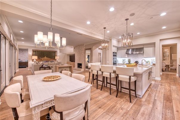 Chandelier, Dining room, Interior, Kitchen, Living room, Pendant Lights, Recessed Lighting, Stainless Steel Appliances, Wood Texture Flooring
