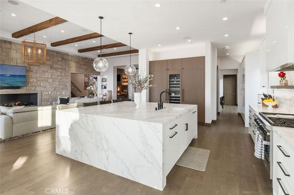 Fireplace, Interior, Kitchen, Living room, Pendant Lights, Recessed Lighting, Stainless Steel Appliances, Stone Walls, Wooden Beams, Wood Texture Flooring