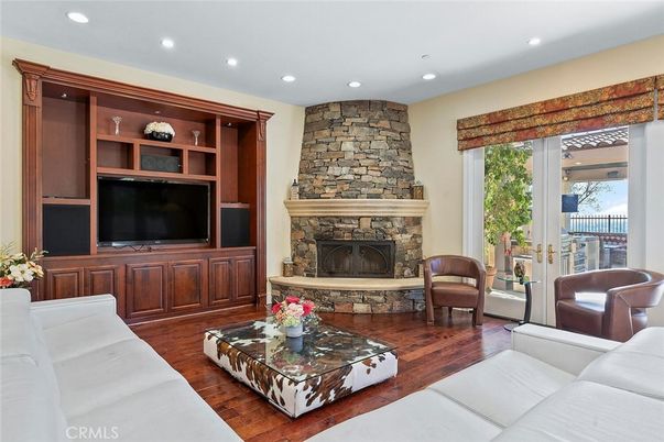 Fireplace, Interior, Living room, Recessed Lighting, Stone Walls, Wood Texture Flooring