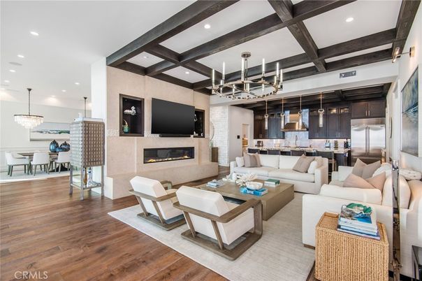 Chandelier, Dining room, Fireplace, Interior, Kitchen, Living room, Pendant Lights, Recessed Lighting, Stainless Steel Appliances, Wooden Beams, Wood Texture Flooring