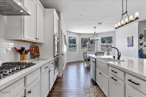 Chandelier, Dining room, Interior, Kitchen, Pendant Lights, Recessed Lighting, Stainless Steel Appliances, Wood Texture Flooring