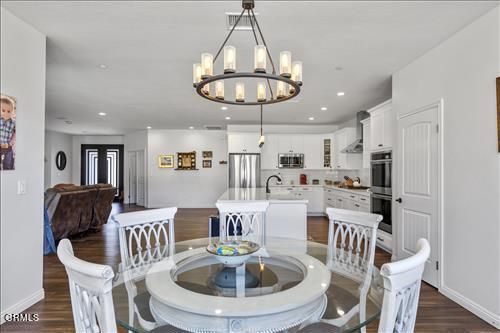 Chandelier, Dining room, Interior, Kitchen, Recessed Lighting, Stainless Steel Appliances, Wood Texture Flooring