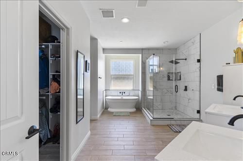 Bathroom, Free Standing Baths, Glass Shower, Interior, Marble Walls, Recessed Lighting, Wood Texture Flooring