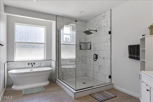 Bathroom, Free Standing Baths, Glass Shower, Interior, Marble Walls, Recessed Lighting, Wood Texture Flooring