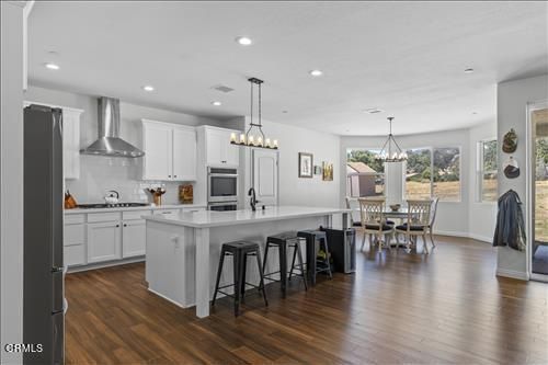 Chandelier, Dining room, Interior, Kitchen, Pendant Lights, Recessed Lighting, Stainless Steel Appliances, Wood Texture Flooring