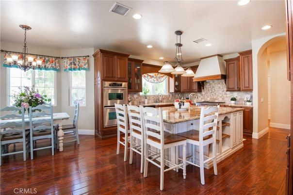 Chandelier, Dining room, Interior, Kitchen, Pendant Lights, Recessed Lighting, Stainless Steel Appliances, Wood Texture Flooring