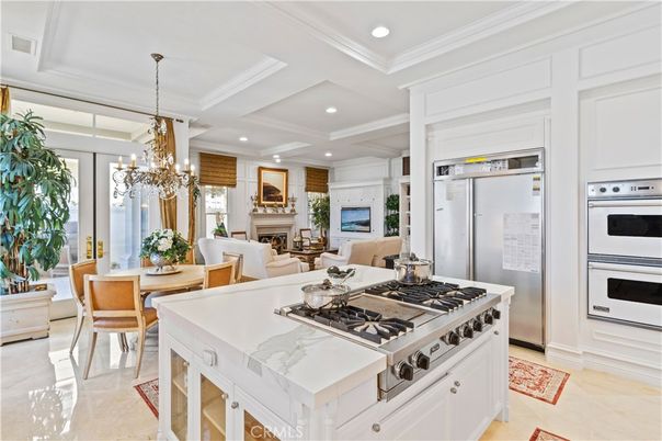 Chandelier, Dining room, Fireplace, Interior, Kitchen, Living room, Pendant Lights, Recessed Lighting, Stainless Steel Appliances