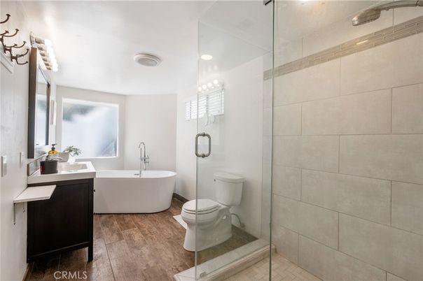 Bathroom, Free Standing Baths, Glass Shower, Interior, Recessed Lighting, Wood Texture Flooring