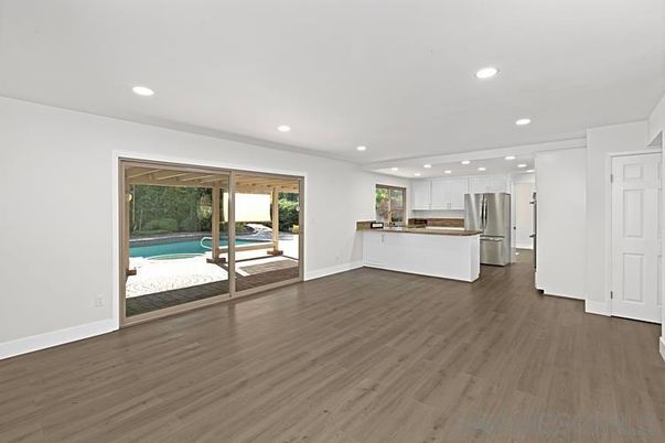 Empty room, Interior, Kitchen, Recessed Lighting, Stainless Steel Appliances, Wood Texture Flooring