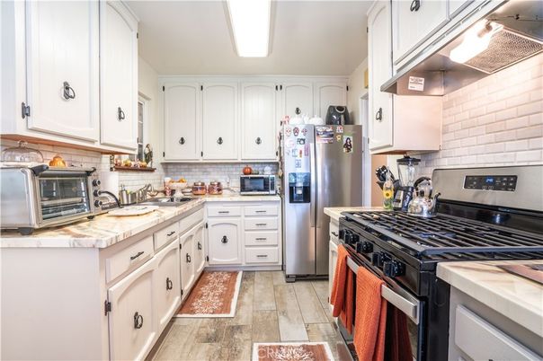 Interior, Kitchen, Stainless Steel Appliances, Tile Countertops, Wood Texture Flooring