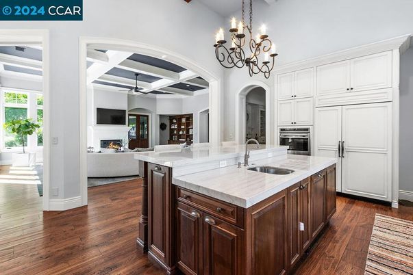 Chandelier, Fireplace, Interior, Kitchen, Living room, Stainless Steel Appliances, Wood Texture Flooring