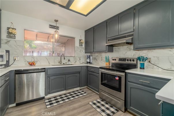 Interior, Kitchen, Marble Walls, Pendant Lights, Stainless Steel Appliances, Wood Texture Flooring