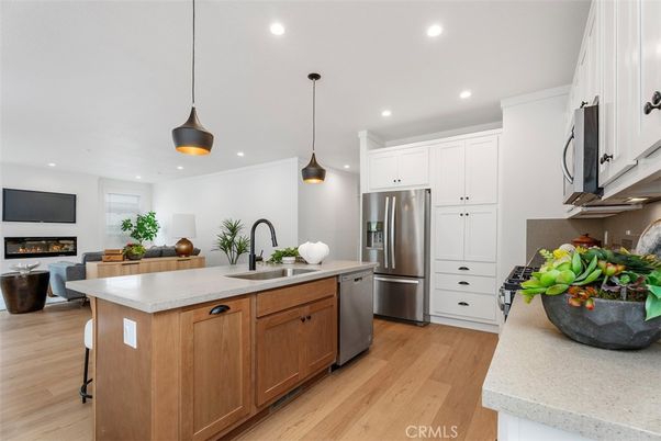 Fireplace, Interior, Kitchen, Living room, Pendant Lights, Recessed Lighting, Stainless Steel Appliances, Wood Texture Flooring