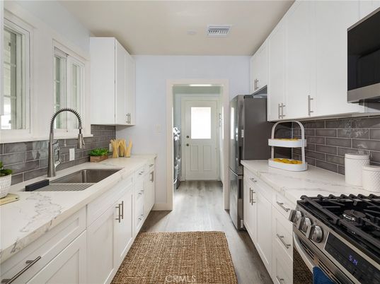 Dining room, Interior, Kitchen, Recessed Lighting, Stainless Steel Appliances, Wood Texture Flooring