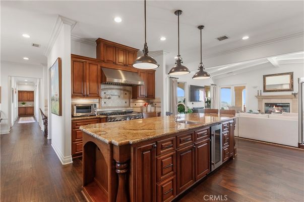 Fireplace, Interior, Kitchen, Living room, Pendant Lights, Recessed Lighting, Stainless Steel Appliances, Wood Texture Flooring