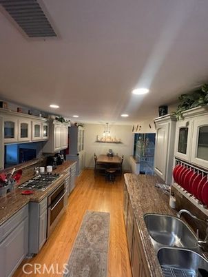 Chandelier, Dining room, Interior, Kitchen, Recessed Lighting, Stainless Steel Appliances, Wood Texture Flooring