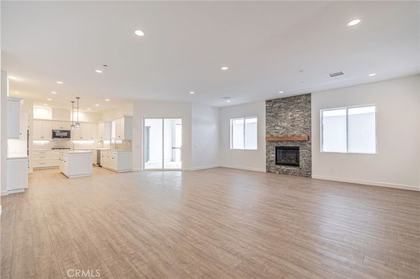 Empty room, Fireplace, Interior, Kitchen, Pendant Lights, Recessed Lighting, Stone Walls, Wood Texture Flooring