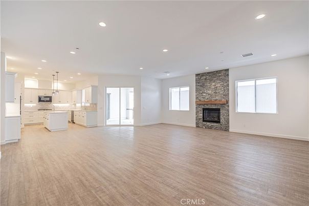 Empty room, Fireplace, Interior, Kitchen, Pendant Lights, Recessed Lighting, Stone Walls, Wood Texture Flooring