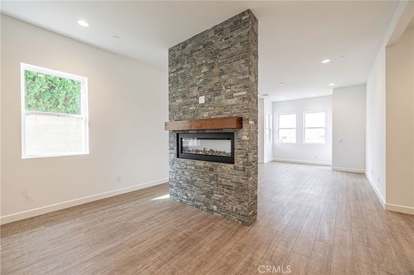 Empty room, Fireplace, Interior, Recessed Lighting, Stone Walls, Wood Texture Flooring