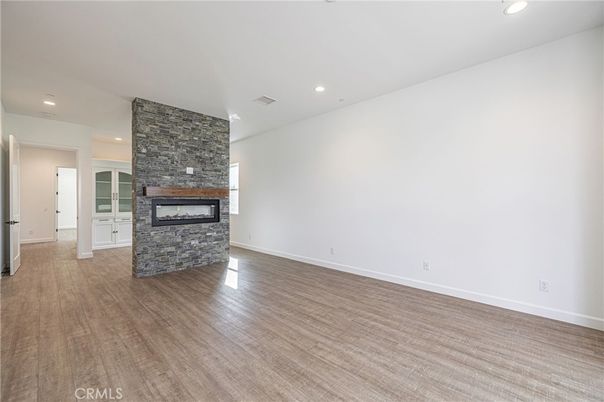 Empty room, Fireplace, Interior, Recessed Lighting, Stone Walls, Wood Texture Flooring
