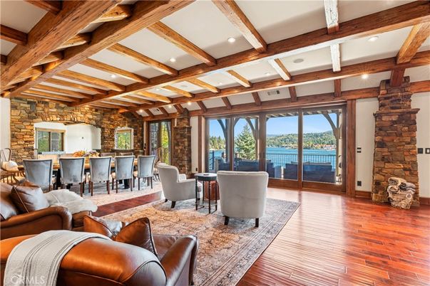 Dining room, Fireplace, Interior, Living room, Recessed Lighting, Stone Walls, Water, Wooden Beams, Wood Texture Flooring