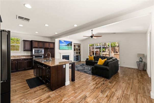 Fireplace, Interior, Kitchen, Living room, Recessed Lighting, Stainless Steel Appliances, Wood Texture Flooring