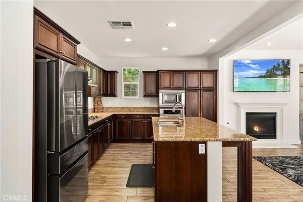 Fireplace, Interior, Kitchen, Recessed Lighting, Stainless Steel Appliances, Wood Texture Flooring