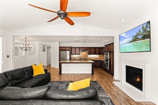 Chandelier, Fireplace, Interior, Kitchen, Living room, Recessed Lighting, Stainless Steel Appliances, Wood Texture Flooring
