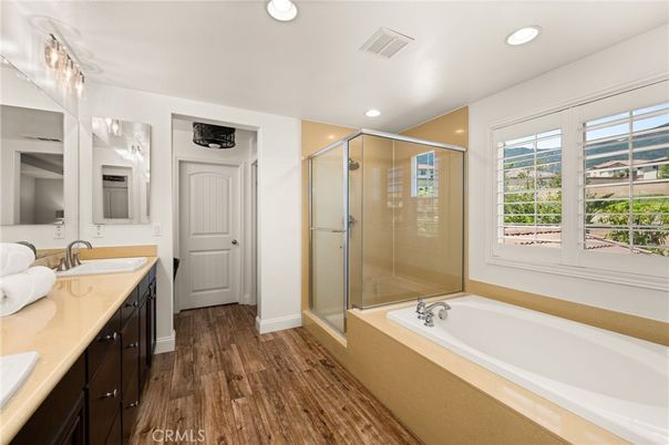 Bathroom, Dual Sink Vanities, Glass Shower, Interior, Recessed Lighting, Wood Texture Flooring