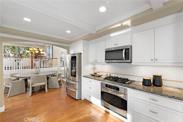 Chandelier, Dining room, Interior, Kitchen, Recessed Lighting, Stainless Steel Appliances, Wood Texture Flooring