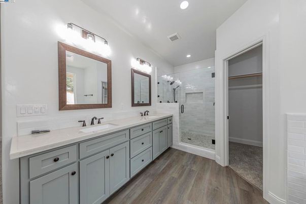 Bathroom, Dual Sink Vanities, Glass Shower, Interior, Recessed Lighting, Wood Texture Flooring