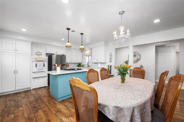 Chandelier, Dining room, Interior, Kitchen, Pendant Lights, Recessed Lighting, Stainless Steel Appliances, Wood Texture Flooring