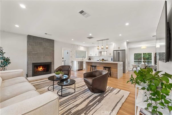 Dining room, Fireplace, Interior, Kitchen, Living room, Pendant Lights, Recessed Lighting, Stainless Steel Appliances, Wood Texture Flooring