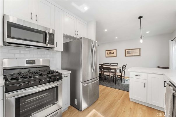 Dining room, Interior, Kitchen, Pendant Lights, Recessed Lighting, Stainless Steel Appliances, Wood Texture Flooring